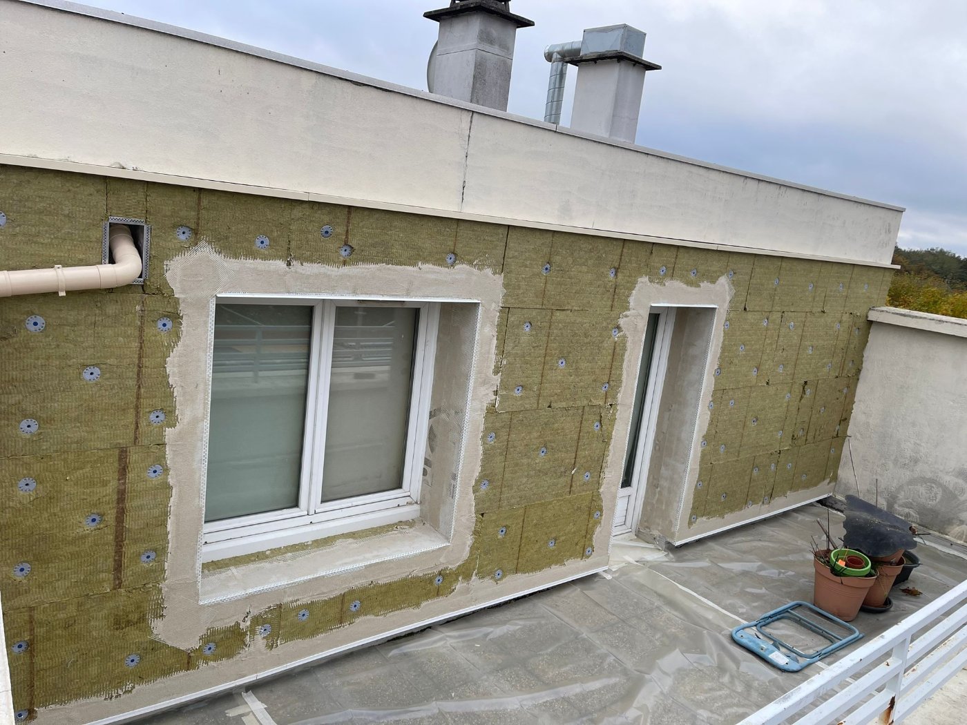 Laine de roche chevillée sur une façade en terrasse, tableaux de fenêtres isolés et premier enduit armé, Boissy-Saint-Léger