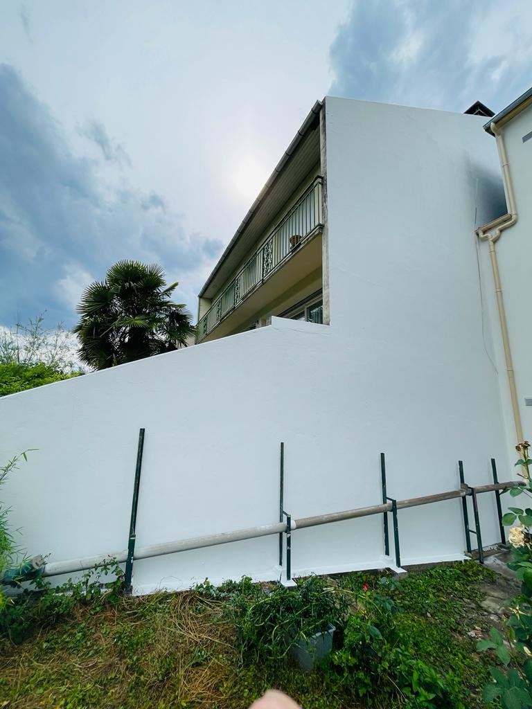 Mur mitoyen d'une maison à Bry-sur-Marne après ravalement et mise en peinture blanche