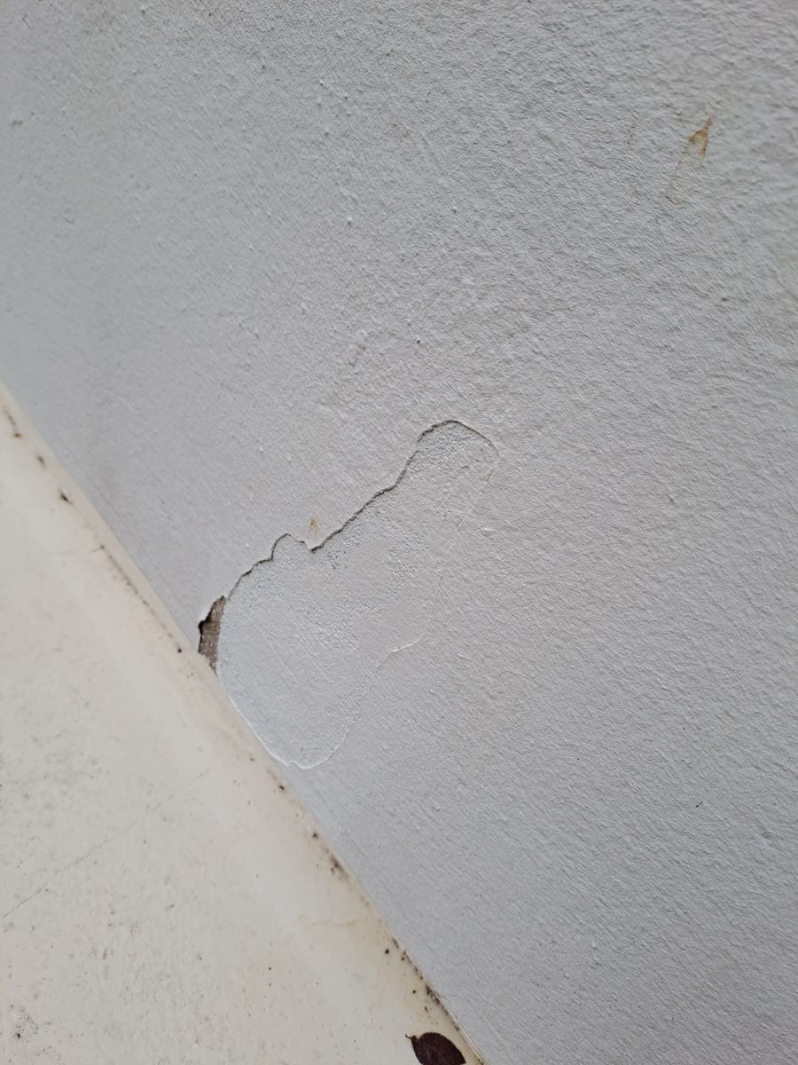 Fissure et enduit qui se décolle en bas de façade sur une maison à Maisons-Alfort, avant isolation par l'extérieur